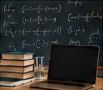 Chalkboard with equations, books and a laptop